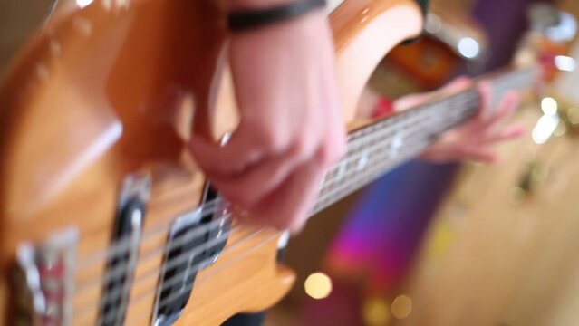 Close up of hands of guitarist playing guitar in recording studio