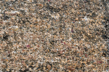 The surface of a concrete wall interspersed with granite as an interesting background.