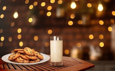 Cozy christmas glass of milk and sweet cookies on desk