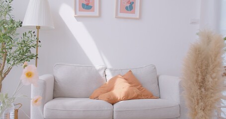 home interior design detail of Modern clean living room with cozy sunlight pillow cushion arrange on gray sofa And white Wall Background