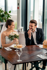 portrait of smiling bride and groom in love newlyweds at wedding in restaurant during celebration of love romance