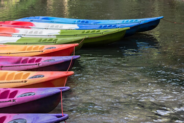 Colorful kayaks on the shore of lake.