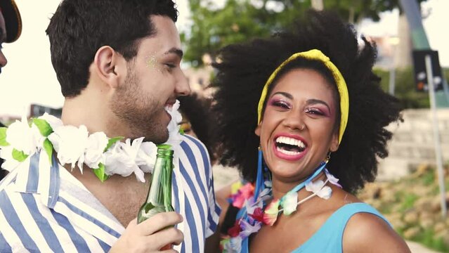 Carnaval Party in Brazil, brazilian couple and friends having fun at parade festival in costume