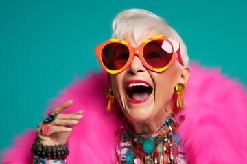 Happy funny senior woman in bright colorful neon outfit - obrazy, fototapety, plakaty