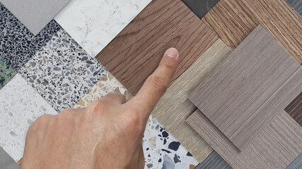 interior decorator picks palette of material samples. mood board contains multi texture and color...