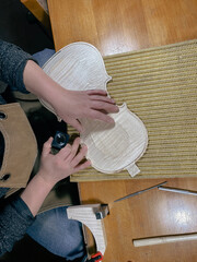 violinmaker performing purfling to new raw violin top plate using loupe to check inlaid channel