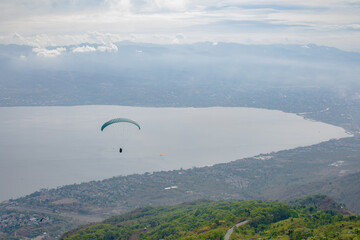 Paragliding soars at salena peak, palu city, Central sulawesi.