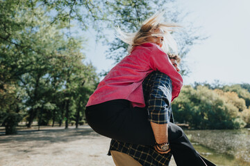 Carefree friends enjoying nature in a city park on a sunny day. Laughter, conversations, and...