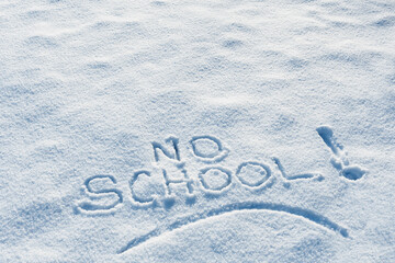 NO SCHOOL writing in the snow after a storm