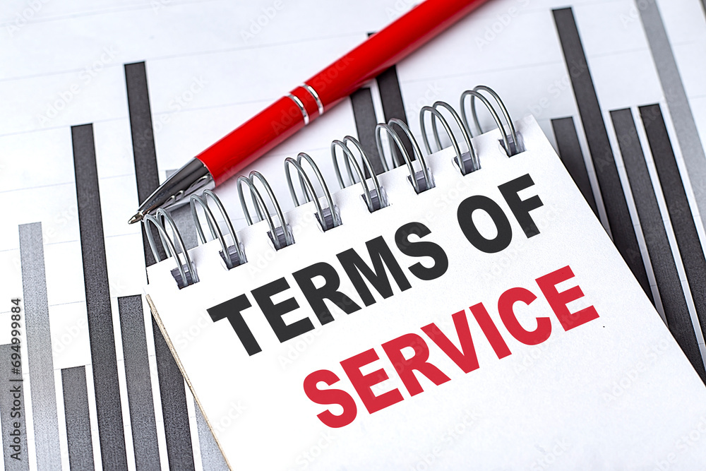 Poster terms of service text written on notebook with pen on chart