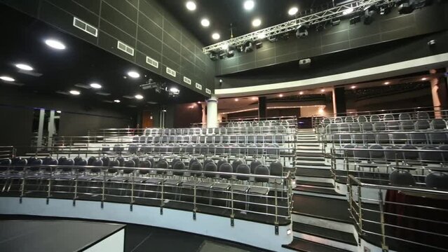 auditorium with chairs, handrails and stage in modern hall