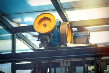 Elevator motor with pulleys and steel cables. lift engine.