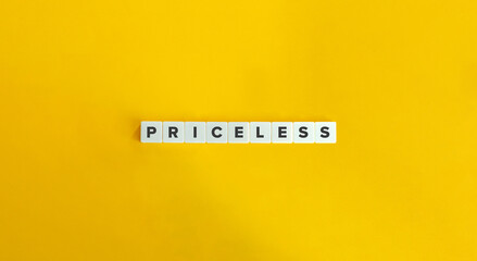 Priceless Word on Block Letter Tiles on Yellow Background. Minimalist Aesthetics.