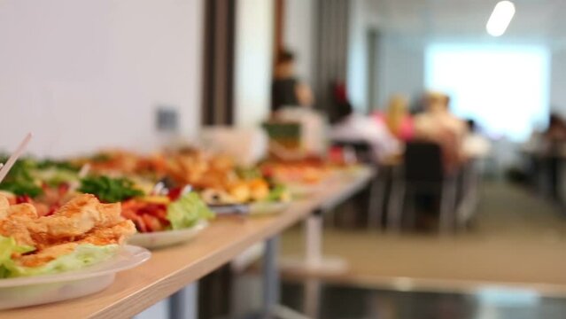 Many plates with different snacks on table in room