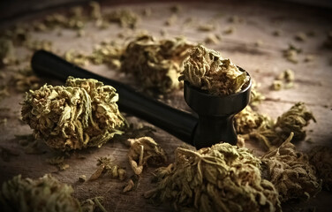 Dry CBD cannabis with metal smoking pipe