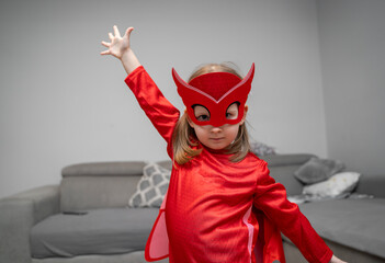 Cute little t in red super hero suit, just having fun and saving the day 
