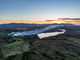Smoke over Lough Fad due to traditionally burning of waste in rural Ireland - County Donegal