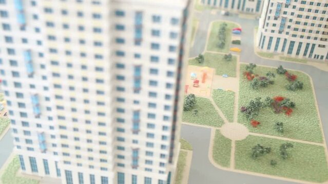 Layout of buildings and courtyard with playground, trees, grass