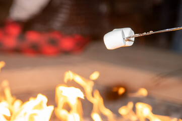 roasting marshmallows at a fire
