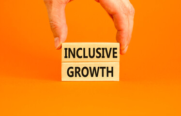 Inclusive growth symbol. Concept words Inclusive growth on beautiful wooden blocks. Beautiful orange table orange background. Businessman hand. Business inclusive growth concept. Copy space.