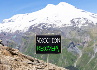 Addiction recovery symbol. Concept words Addiction recovery on beautiful black chalk blackboard. Beautiful mountain Elbrus blue sky background. Psychology addiction recovery concept. Copy space.