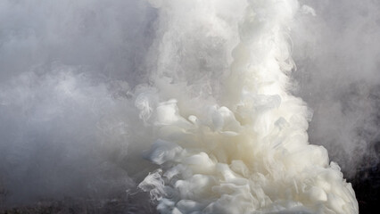 Texture of smoke of gray and white colors in sunlight