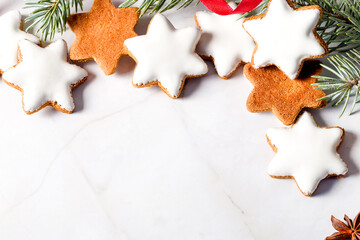 Traditional Christmas glazed gingerbread cookies in the shape of a star. Cookies for the holiday. New Year's decor. Red background. Copy space. Flat lay