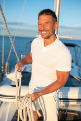 Contented and determined mature man on a yacht