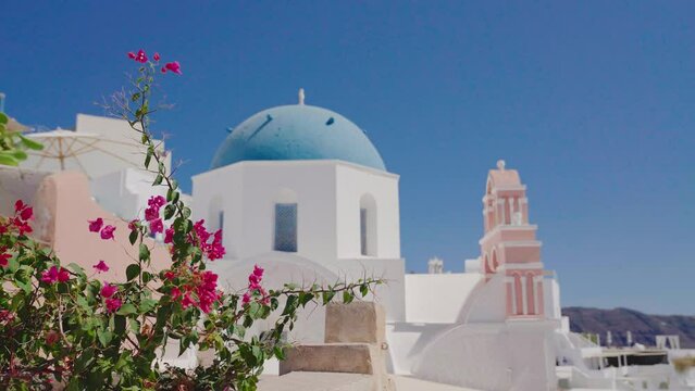 Panoramic view of Three Bells of Fira blue dommed church over caldera and vulcano island with anchored Cruiser ferry boats, Santorini, Greece
