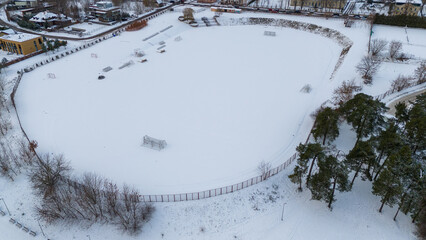 Drone photography of soccer field in winter covered by snow