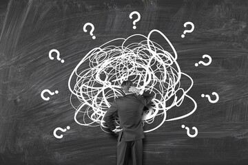 Businessman Looking At questions marks searching For Solution.