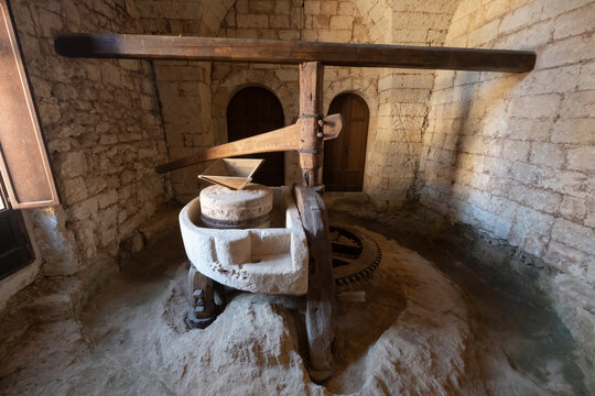 Ancient oil mill underground mill Grey brick walls. Sunlight coming through the door. Santa Maria a Cerrate, Puglia, Italy