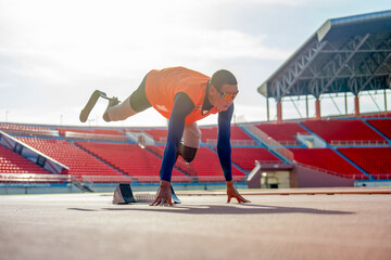 Sport man athlete with a prosthesis on his leg lie down and action of stretch one leg back and up...