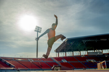Front view of sport man athlete prosthesis legs jump up in front of sun light in the afternoon of...