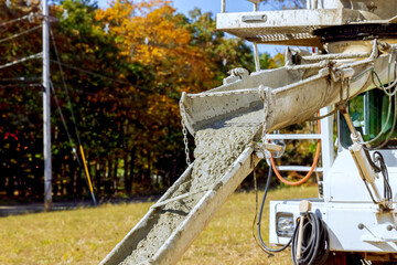 Concrete mixer truck poured liquid cement concrete at construction site