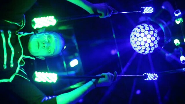 Bottom view of man in samurai garb performing with glow sticks