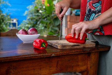 Woman ready to cut a red bell pepper