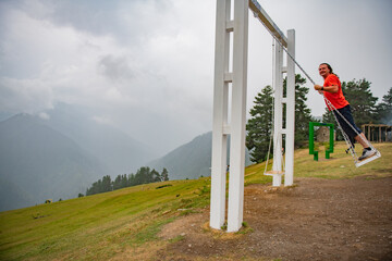 The man enjoying the freedom and the wind in his hair while swinging