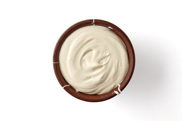 Brown clay bowl with yogurt isolated on white background. Top view with copy space