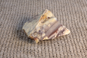 Pelitic Schist Rock on beige knitted fabric Background