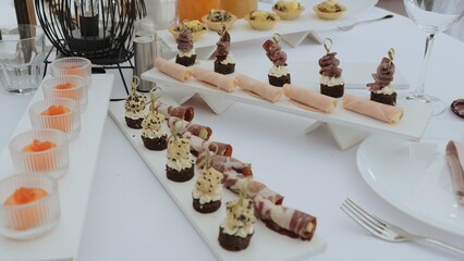 Business lunch. A beautiful festive table covered with a variety of food. Food and drinks on the festive table in the restaurant. Beautifully decorated banquet table with appetizers.
