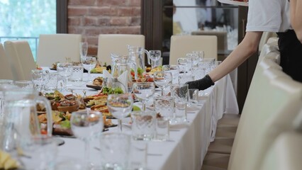 A beautiful festive table covered with a variety of food. Food and drinks on the festive table in the restaurant on birthdays, weddings. Beautifully decorated banquet table with appetizers.