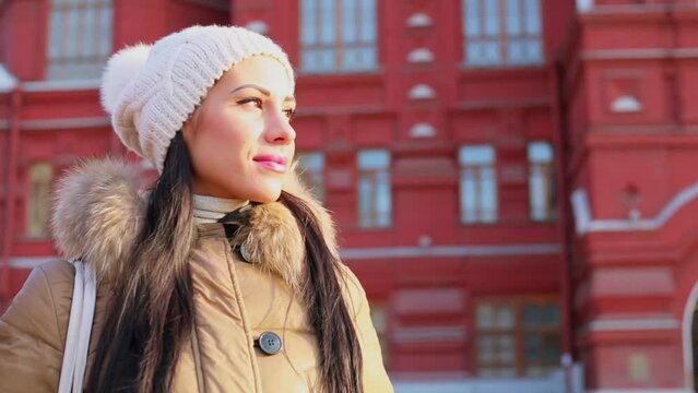 woman looks around while stand near building of Historical museum