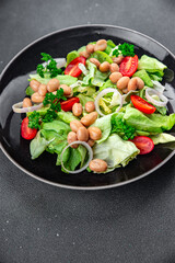 white bean salad green lettuce, tomato healthy eating cooking appetizer meal food snack on the table copy space food background rustic top view 