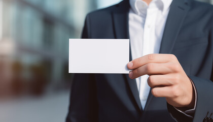 man is holding a blank business card