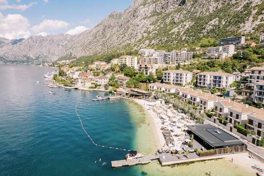 Private beach in front of the luxury villas of the Huma Kotor Bay hotel. Dobrota, Montenegro. Drone