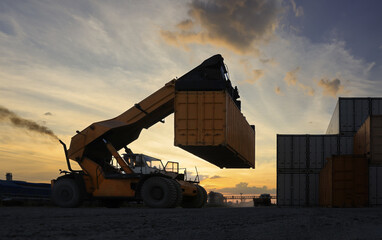 Silhouette Truck container lifter load and unload Cargo container in Logistic shipping yard