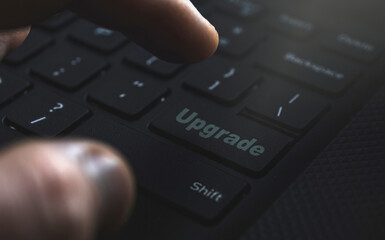 Close-up of a hand confidently selecting the 'Upgrade' option. Illustrating the concept of seamless...
