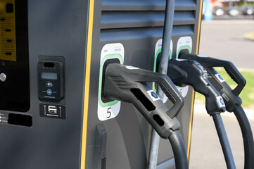 Close-up of the charging pistols on an electric charging station.