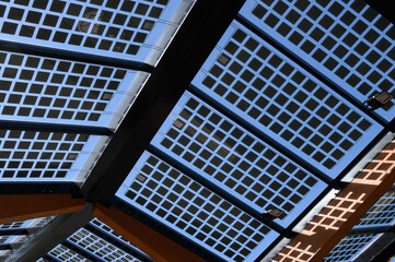 The photovoltaic roof of an electric charging station at a roadside car park.